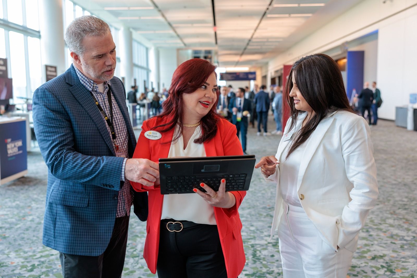 Javits staff members working with a client at the Javits Center.